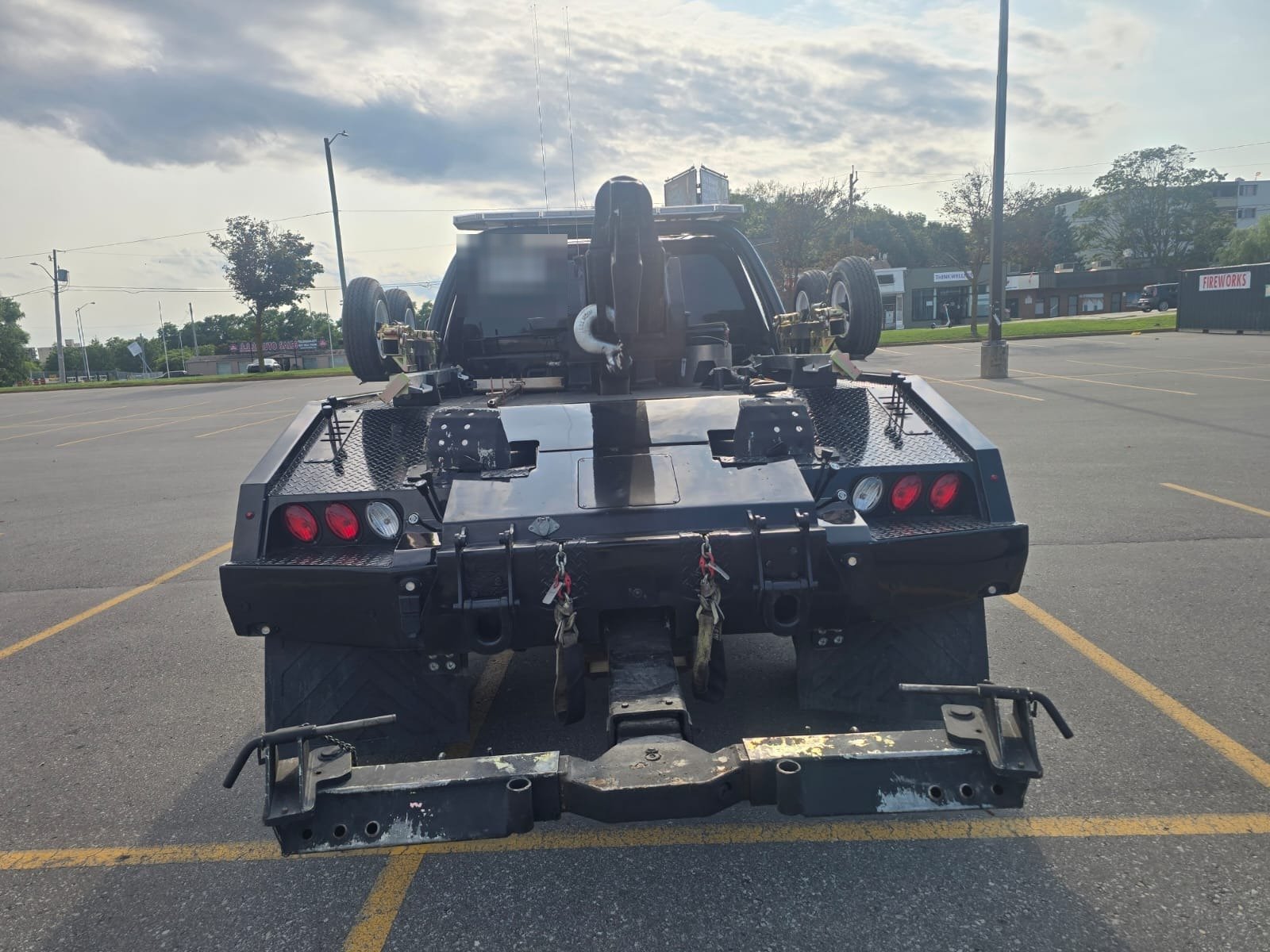 Rear view of the One Ummah Towing wheel lift tow truck